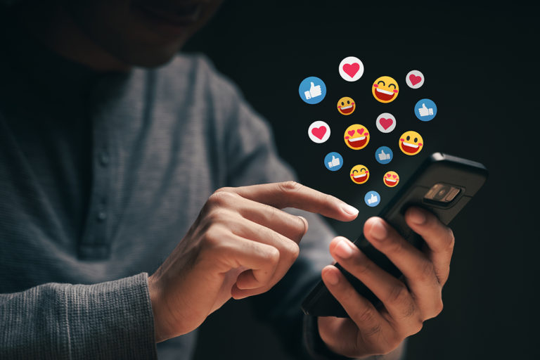 Happy young man using smartphone chatting on Social network send